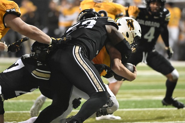 Colorado Buffaloes defensive end Arden Walker (53) sacks Wyoming Cowboys...