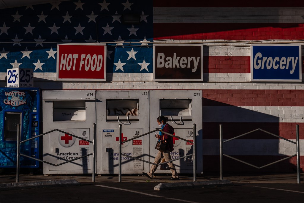 A woman walks in front of Garden Farms Market on Dec. 10, 2022.