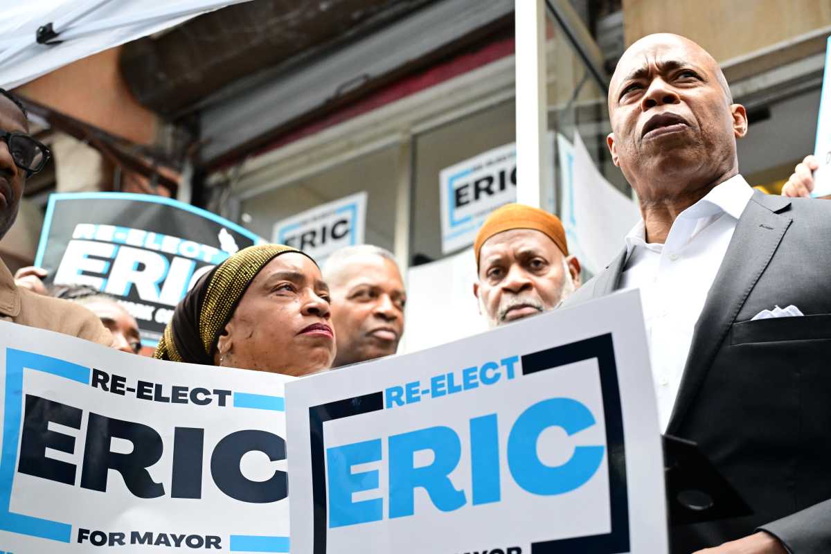 Mayor Eric Adams addresses supporters at his Harlem campaign office Wednesday, attacking opponents over rent-stabilized apartments and touting his administration’s affordable housing record