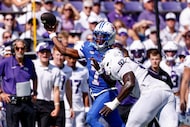 SMU quarterback Kevin Jennings (7) throws a pass under pressure from TCU edge Paul Oyewale...