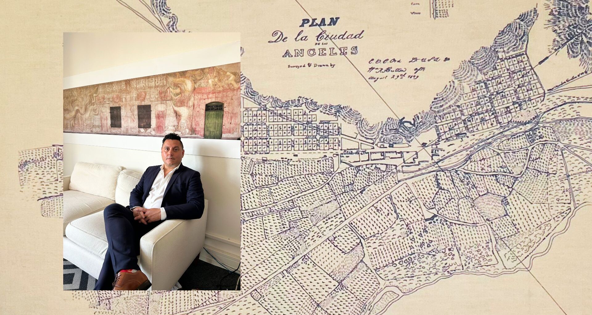 Photo of Edgar Garcia sitting on a couch over a large map of Los Angeles.