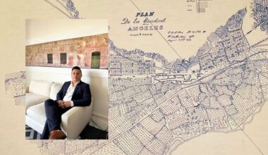 Photo of Edgar Garcia sitting on a couch over a large map of Los Angeles.