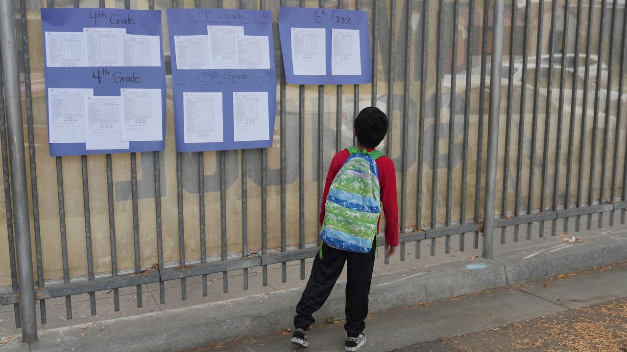 A student arrives on the first day of school Thursday, Aug. 14, 2025, in Los Angeles. (AP Photo/Marcio Jose Sanchez)