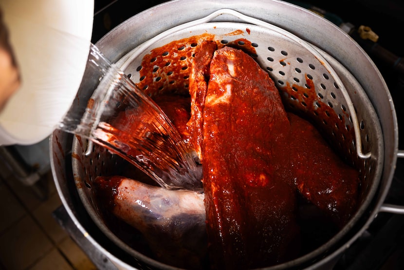 Water is added to the pot before the birria is cooked at Birrieria Aguiñaga in Dallas on...