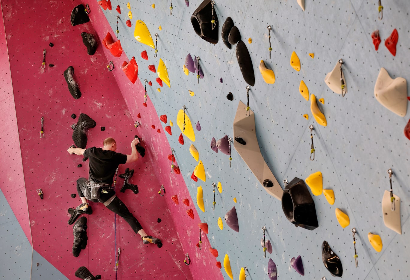 Advanced climber Brett Webster of Addison maneuvers through the holds as he ascends a...