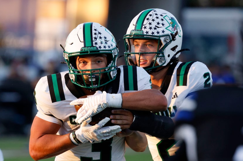 Southlake Carroll's quarterback Angelo Renda (2) hands off to Southlake Carroll's Davis Penn...