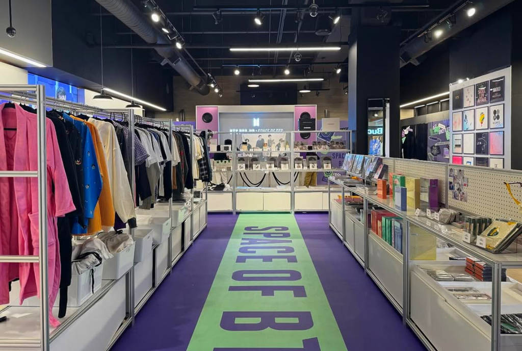 Image shows clothing and merchandise at the BTS pop-up in Houston Galleria.