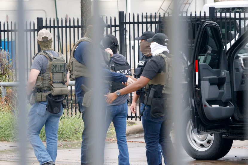 Officers including Homeland Security Investigations (HIS) gather around 1120 Empire Central...