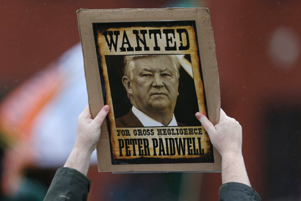 A Celtic fan protests against Celtic board member Peter Lawwell