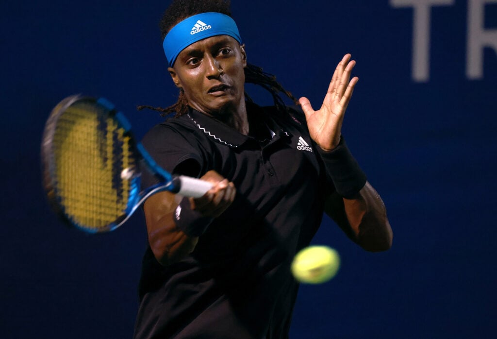 Mikael Ymer of Sweden returns a shot to Carlos Alcaraz of Spain during the semifinals of the Winston-Salem Open at Wake Forest Tennis Complex.
