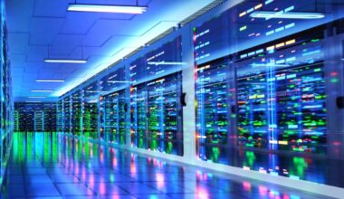 Stylized server room in data center with colored lights reflected in shiny floor.