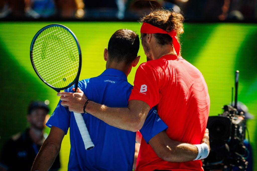 Novak Djokovic and Alexander Zverev embrace after their semifinal match at the 2025 Australian Open