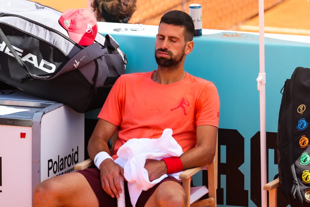 Novak Djokovic sits down during the 2025 Madrid Open