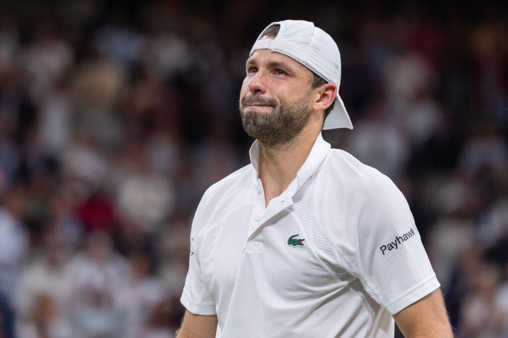 Grigor Dimitrov crying after retiring due to injury against Jannik Sinner at Wimbledon.