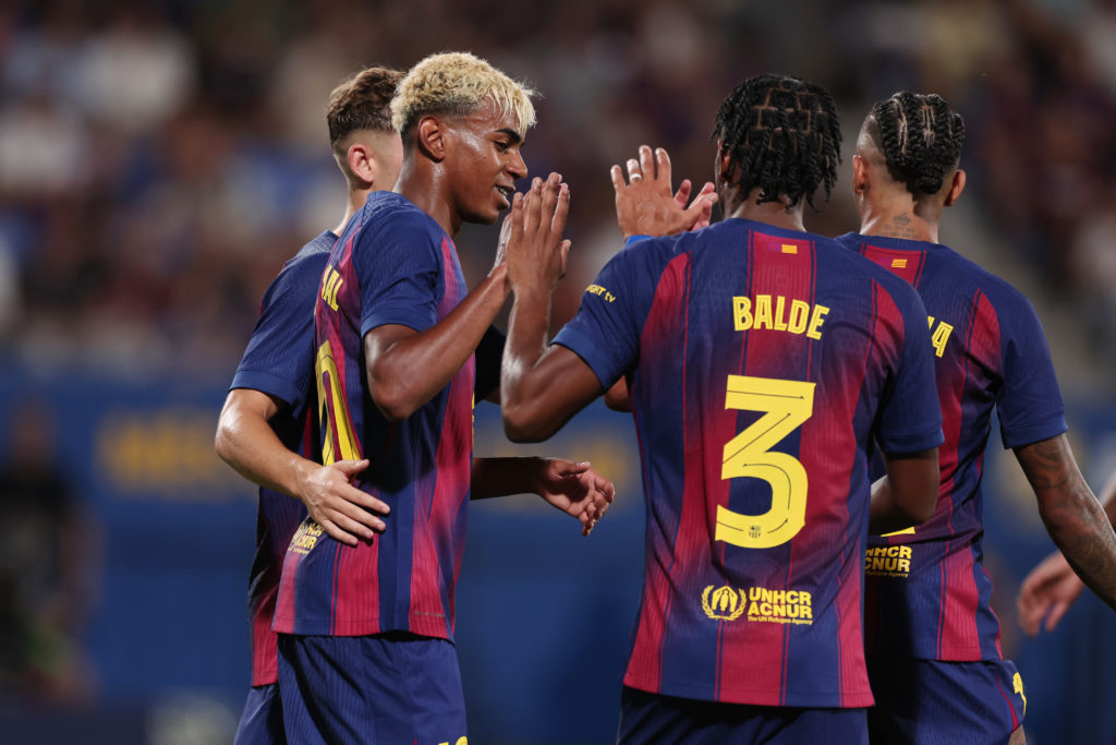Lamine Yamal and Alejandro Balde celebrate FC Barcelona's goal against Como in a pre-season friendly.