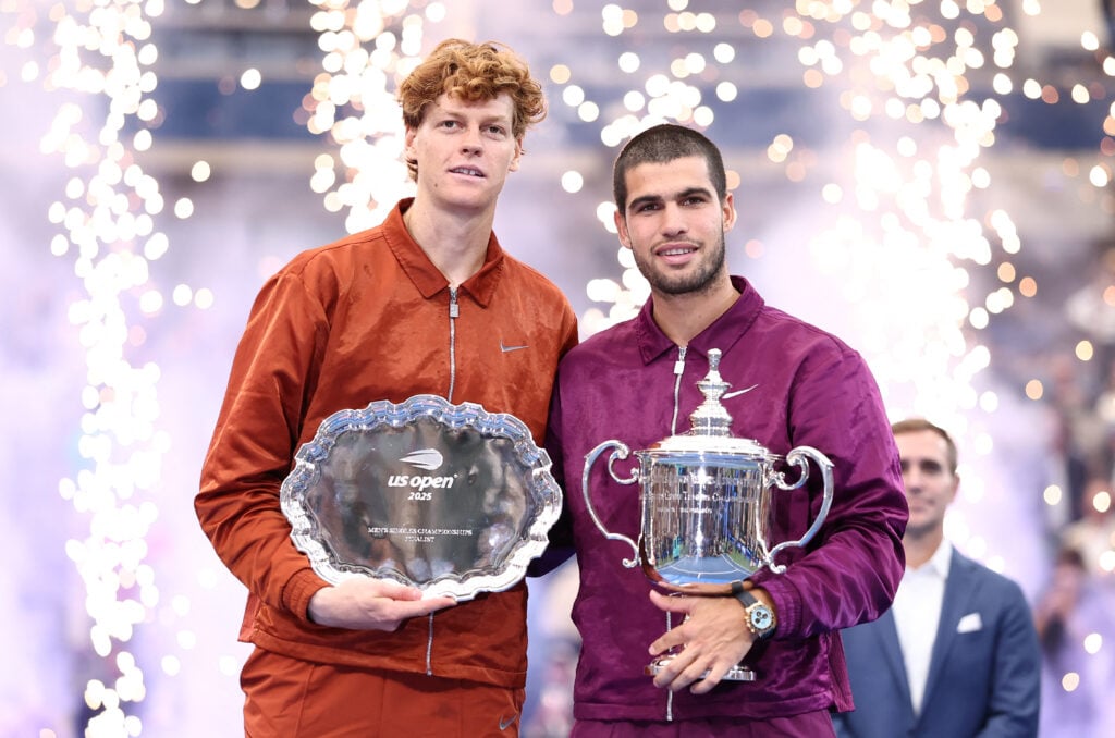 Spain's Carlos Alcaraz and Italy's Jannik Sinner pose with their trophies after Alcaraz won the men's singles final tennis match on day fifteen of the US Open tennis tournament at the USTA Billie Jean King National Tennis Center in New York City.