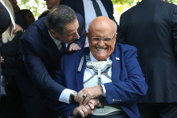 (L/R) Former New York Governor Andrew Cuomo greets former New York City Mayor Rudy Giuliani as they attend the annual 9/11 Commemoration Ceremony at the National 9/11 Memorial and Museum on the 24th anniversary of 9/11 attacks in New York on September 11, 2025. (Photo by TIMOTHY A.CLARY/AFP via Getty Images)