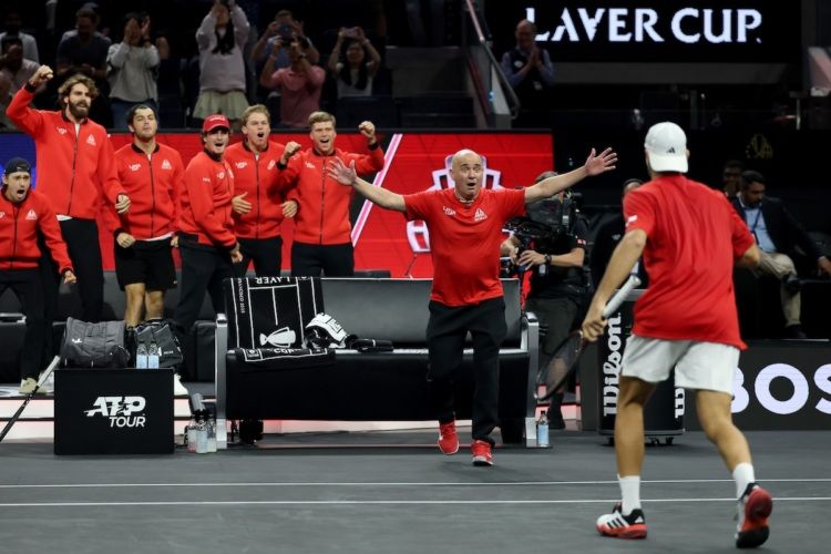 Andre Agassi reaches to embrace an all-star Team World player, Francisco Cerundolo. 