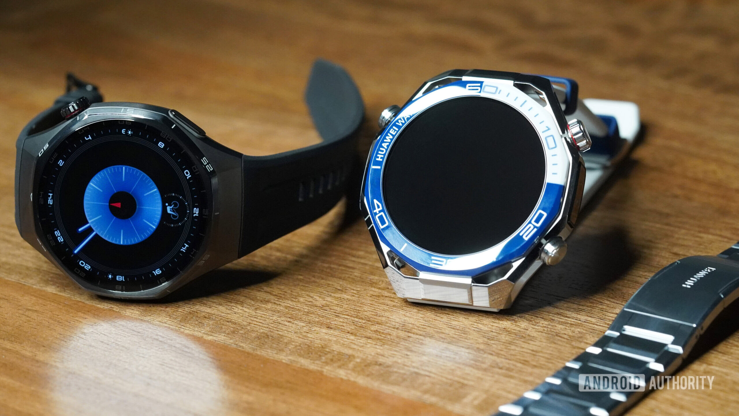 A Huawei Watch GT 6 Pro rests next to a Huawei Watch Ultimate 2.