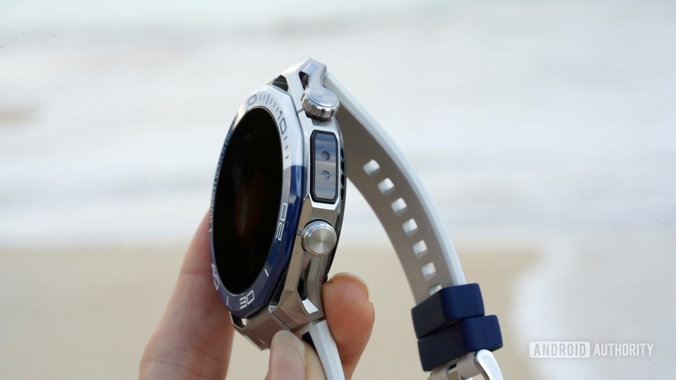 A user holds a Huawei Watch Ultimate 2, showcasing the device's X-Tap sensor.