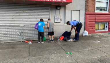 Rookie officer approaches a person on the sidewalk in Kensington
