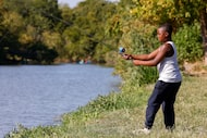 P2 Williams, 10, casts his bait into White Rock Lake, on Aug. 13, 2023, in Dallas. Texas...