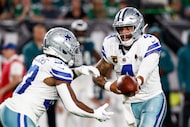 Dallas Cowboys quarterback Dak Prescott (4) hands off to running back Javonte Williams (33)...