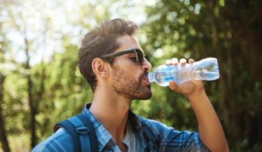 young man stopping for a drink of water