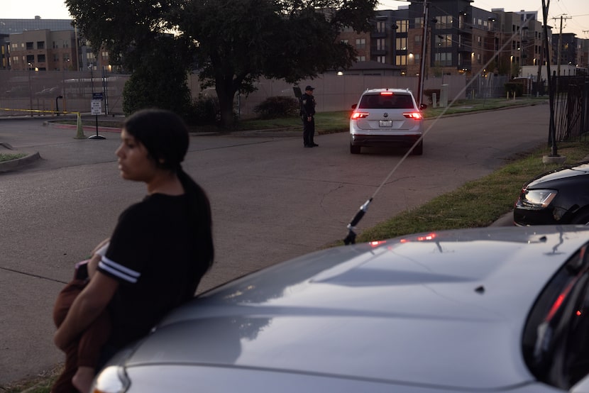Julia Pinto waits outside of the U.S. Immigration and Customs Enforcement with her son,...