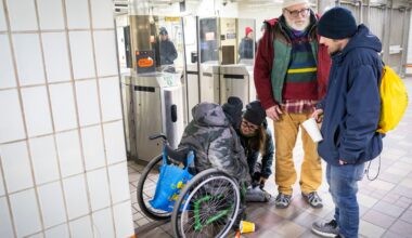 Beckie Tachick, a nurse with the Boston Health Care for the Homeless Program, left kneeling, and Jim Greene, Assistant Director for Street Homelessness Initiatives, Mayor’s Office of Housing, City of Boston, right standing, conduct welfare checks at the Temple Place MBTA Station on Thursday, Jan. 30, with Patrick, far left, and Danny, far right, during the annual homeless count.