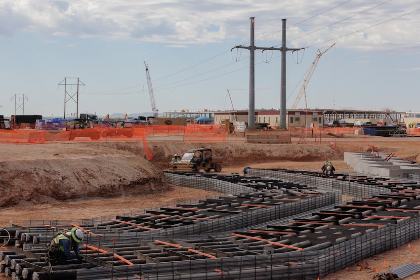 Conduits for fiber to connect superclusters of data centers are under construction during a...