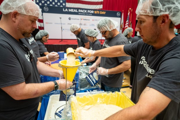 More than 1,300 volunteers joined together to pack meals for...