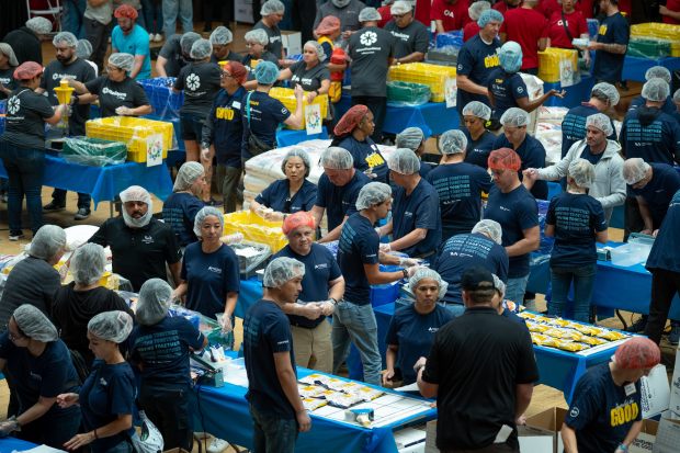 More than 1,300 volunteers joined together to pack meals for...