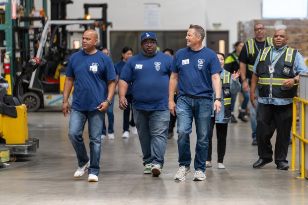 Derrick Robinson, HR Manager, Bureau of Human Resources; James Blunt, DPSS Assistant Director, Bureau of Administrative Services; and Michael Sylvester, DPSS Chief Deputy, Office of Administration, tour the L.A. Regional Food Bank warehouse. (Photo by Temo Reyes)