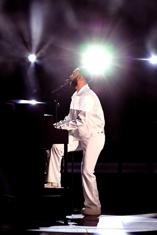 John Legend plays the piano while performing at the Hollywood...