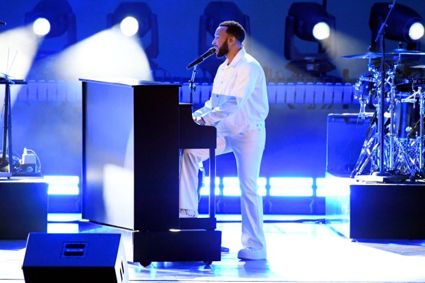 John Legend plays the piano while performing at the Hollywood...