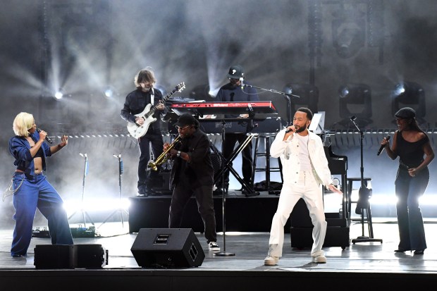 John Legend and members of his band take the stage...