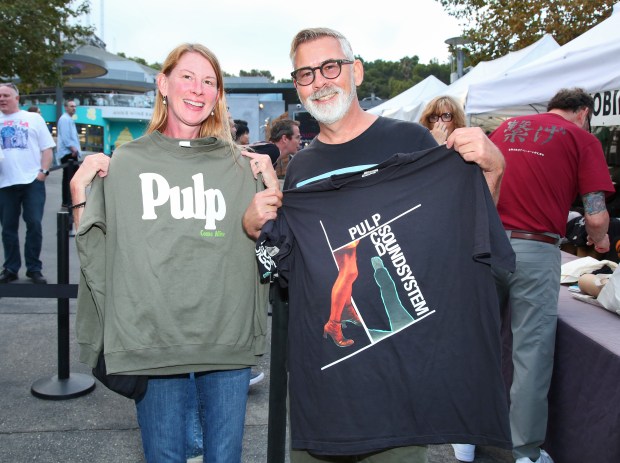 Fans buy T shirts before a co-headlining show by LCD...