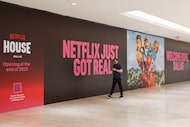 A person walks by an advertisement of the upcoming Netflix House, on Wednesday, July 2,...