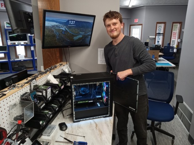 Andrew Vandergrift, a technician at PCS Computers for six months, is working on a computer. (Bob Stascak - For The Morning Journal)