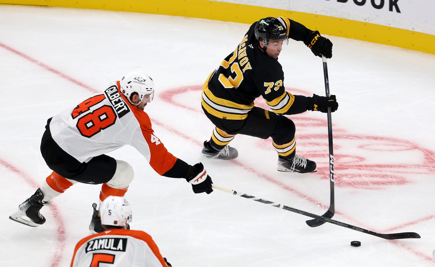 Bruins defenseman Charlie McAvoy puts the puck in front of the Flyers’ net in the first period Monday night.