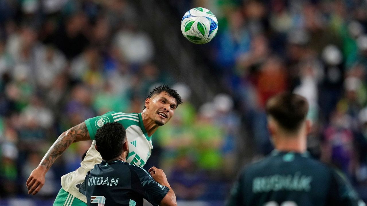 Austin FC forward Brandon Vázquez, facing, heads the ball against Seattle Sounders midfielder Cristian Roldan (7) during the second half of an MLS soccer match Saturday, June 28, 2025, in Seattle. (AP Photo/Lindsey Wasson)