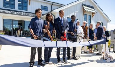 Tiger Woods poses with some TGR Learning Lab students at the grand opening of the Cobbs Creek center that his foundation helped fund.