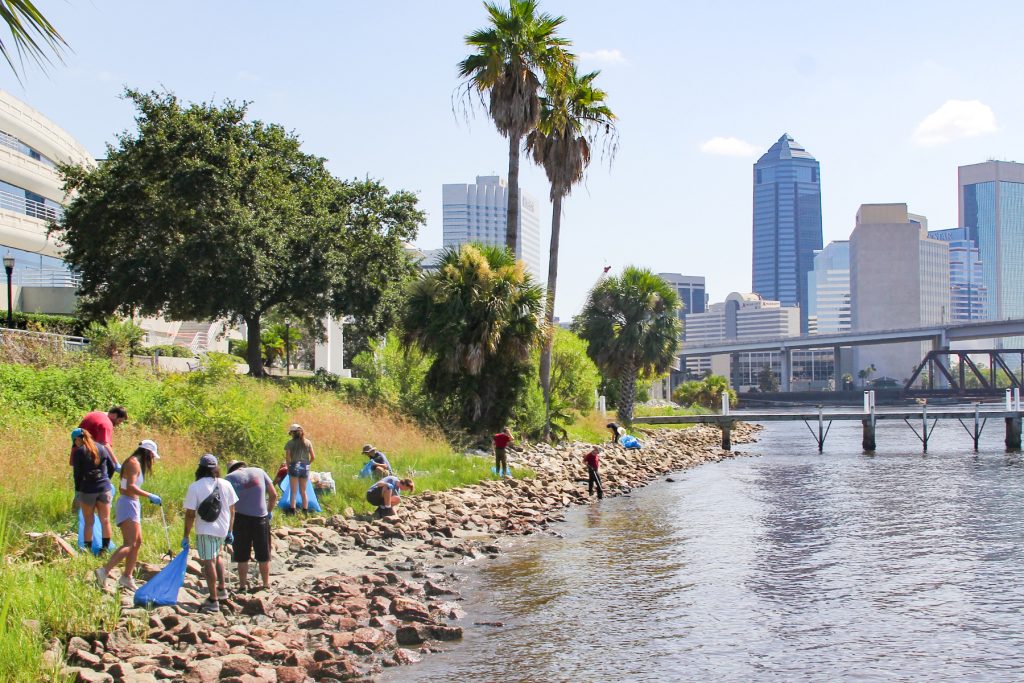Volunteers trek along St. Johns River Sunday, July 20, from the Winston Family YMCA to McCoys Creek removing waste as part of the St. Johns Riverkeeper McCoys Creek Cleanup program.
