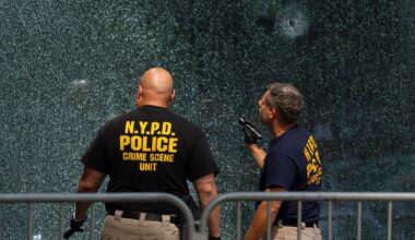 Members of the NYPD's Crime Scene Unit examine a door with bullet holes on Tuesday, July 29, 2025, in New York, the day after the deadly shooting. (AP Photo/Yuki Iwamura, File)