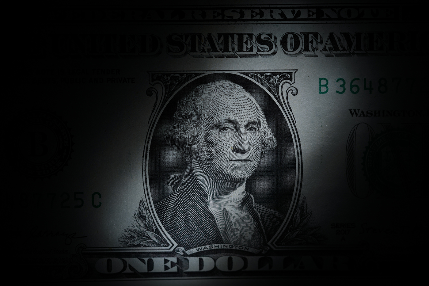 An artsy depiction of the one dollar bill, heavily shaded at the corners.