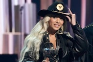FILE - Beyonce, left, accepts the Innovator Award during the iHeartRadio Music Awards, April...