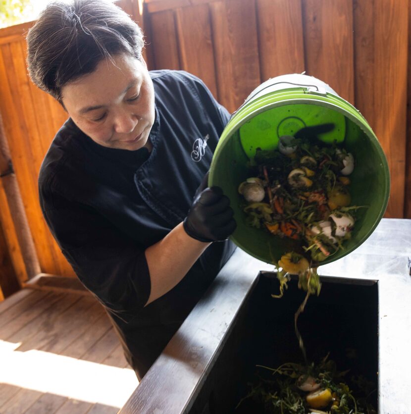 Michelle Carpenter, executive chef and owner of Restaurant Beatrice, adds food scraps and...
