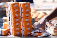 Staff prepares White Castle sliders during an event announcing the arrival of White Castle...