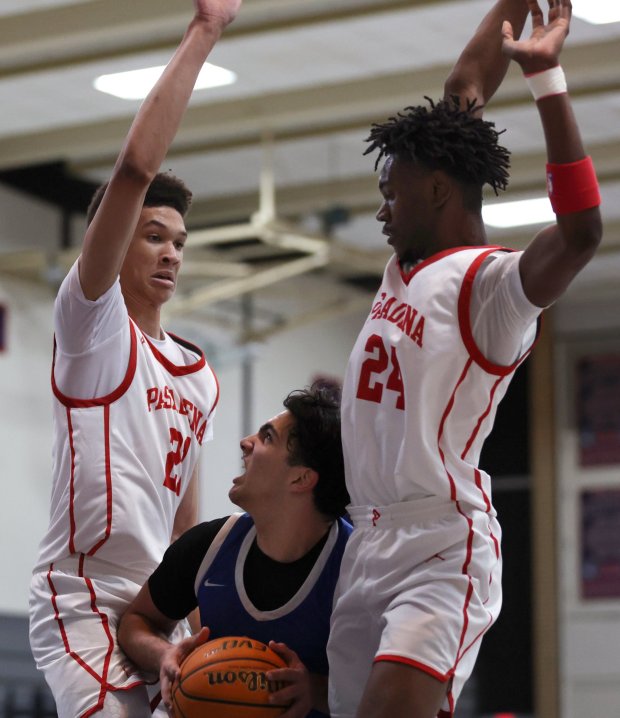 Burbank's Nicholas Niazi is sandwiched between Pasadena's Josh Irving, left, and DeMille Brown II during a boys basketball game at Maranatha High School in Pasadena on Friday, Jan. 23, 2025. (Photo by Trevor Stamp, Contributing Photographer)